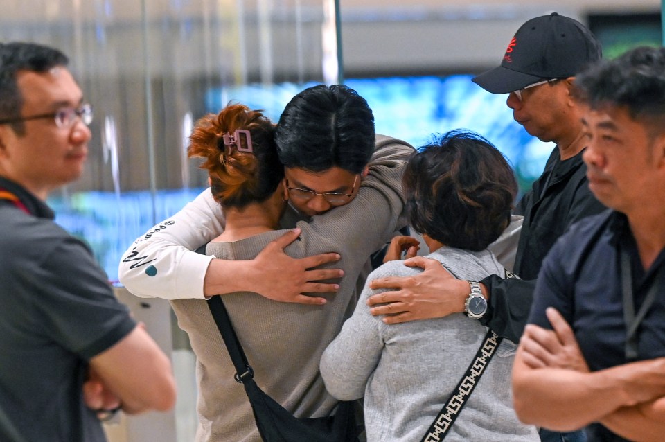 Passengers of Singapore Airlines flight SQ321 greet family members upon arrival at Changi Airport in Singapore