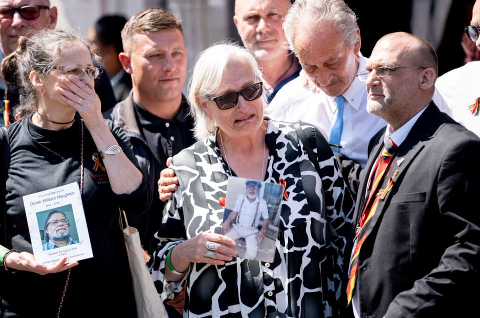 Deborah Dennis (centre), whose husband Barry died, in tears today