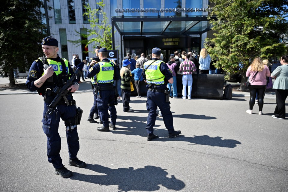 Police stand guard as media await the Eurovision final participants outside the Clarion Hotel in Malmo