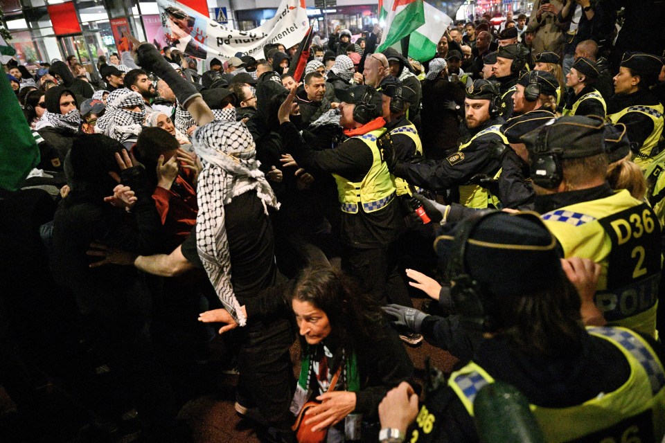 Furious crowds are seen in Malmo during the 68th Eurovision Song Contest