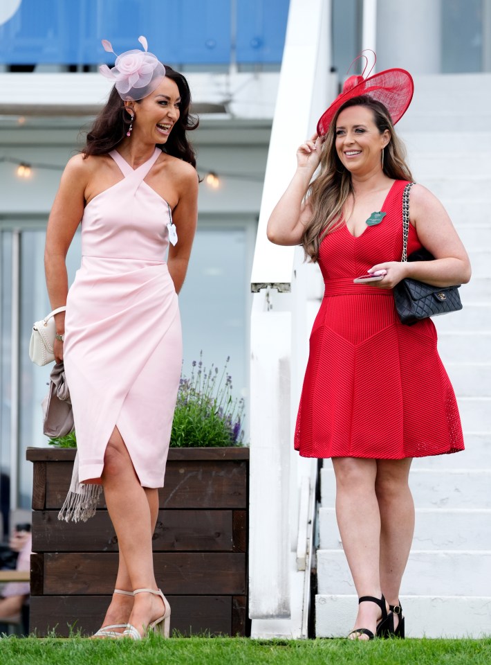 Two beaming friends appeared to be having a ball on Ladies' Day