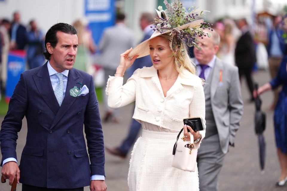 This guest looked impeccable in a cream buttoned jacket and floral hat