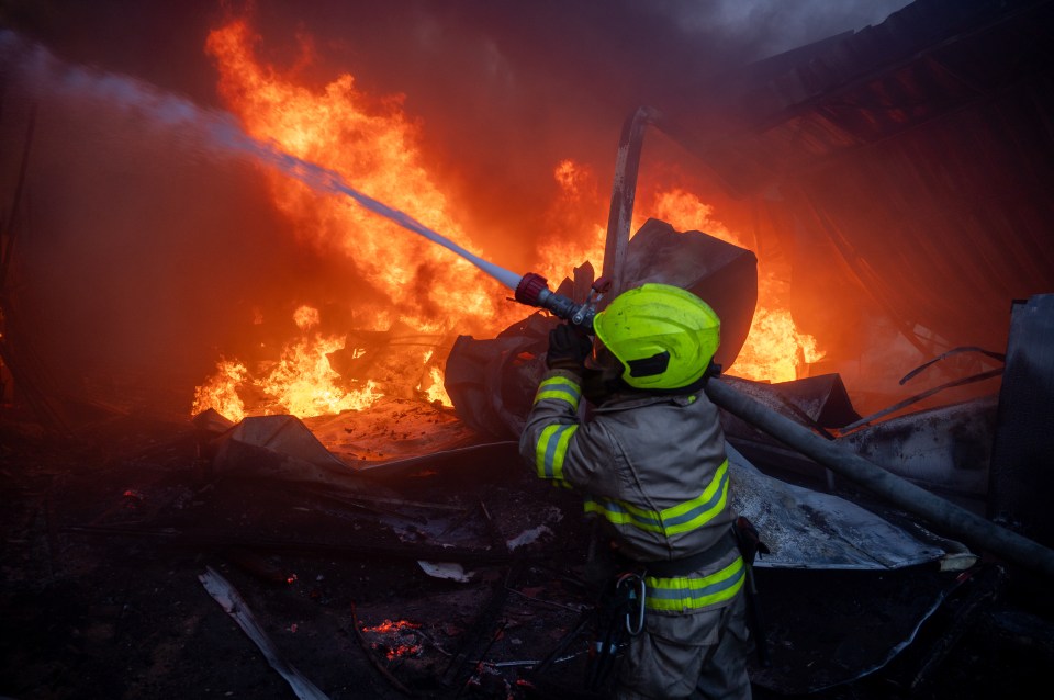 Firefighters attempting to put out a blaze on the outskirts of Kharkiv