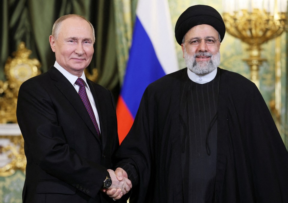 Russian President Vladimir Putin shakes hands with Iranian President Ebrahim Raisi in Moscow in December 2023