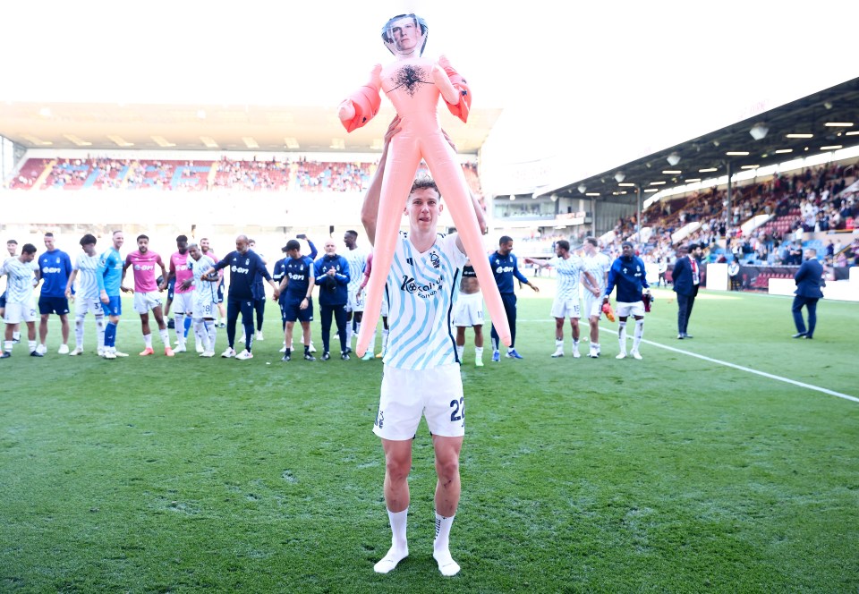 The midfielder held the doll aloft as he celebrated with the travelling Forest fans