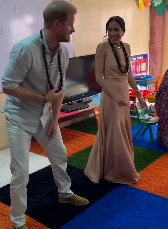 Prince Harry and Meghan Markle danced with school children after they arrived in Nigeria today