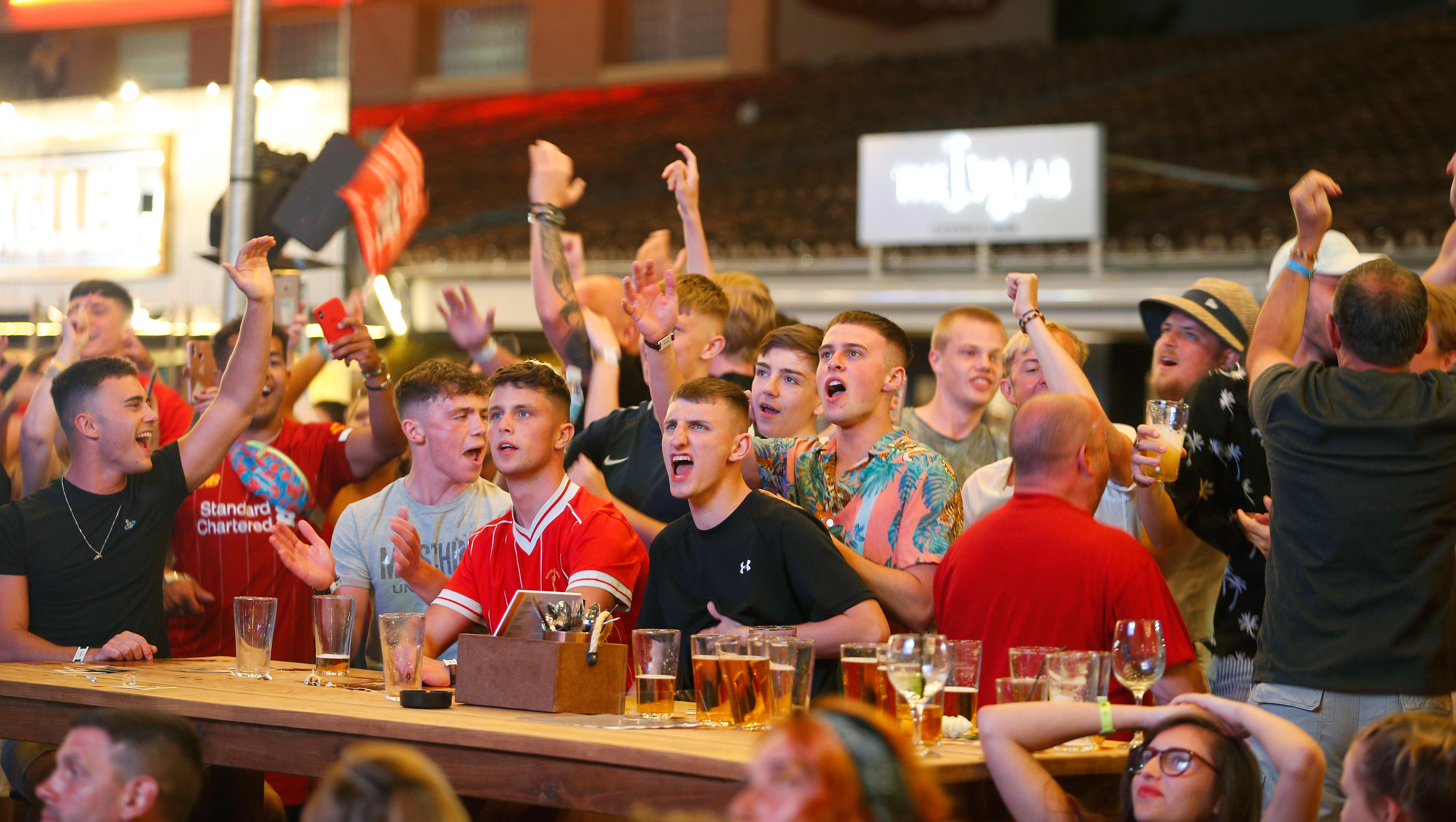 Brit tourists drinking while enjoying a football match in one of the sports bars in Majorca