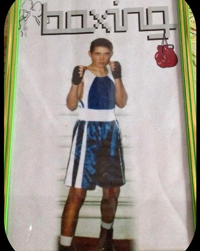 Young Oleksandr Usyk in boxing attire.