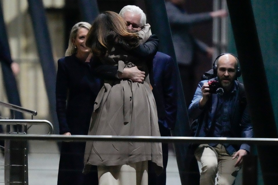 Assange hugs his wife Stella on the tarmac