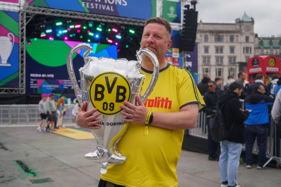 One hopeful Dortmund fan clutches an inflatable trophy