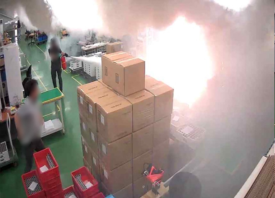 The workers desperately tried to put out the blaze at a Korean factory on Monday