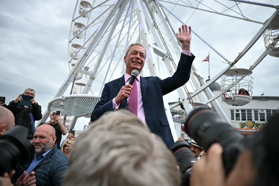 A crowd of several hundred crammed beneath a ferris wheel lapped up his every word