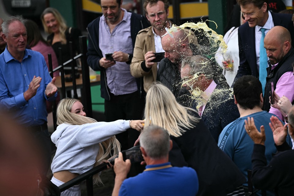 Nigel Farage is covered in milkshake at a campaign event in Clacton