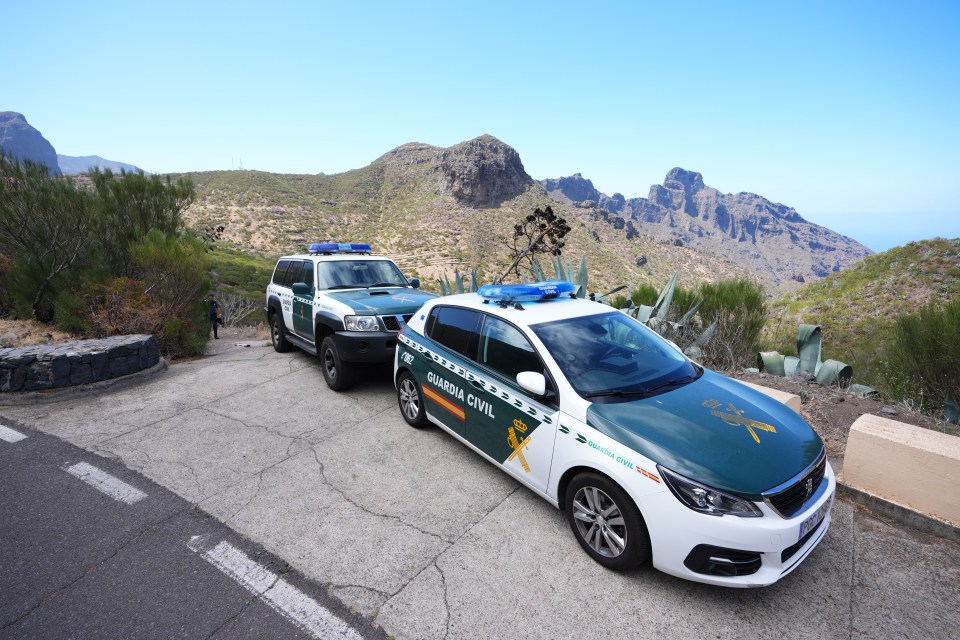 two guardia civil cars are parked on the side of the road