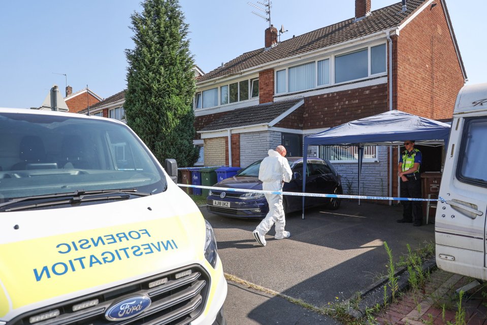 Police and forensic officers at the scene of the double murder probe