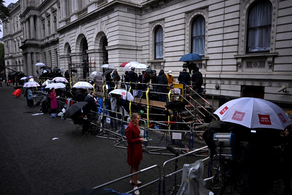 Members of the media wait outside Number 10 Downing Street this morning