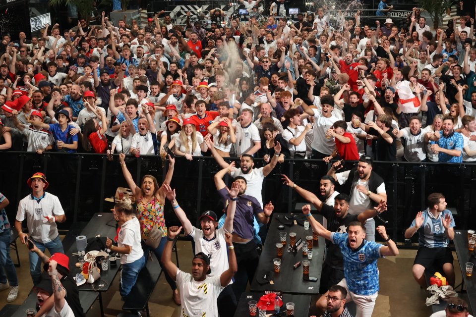 a crowd of people cheering in front of a sign that says x factor