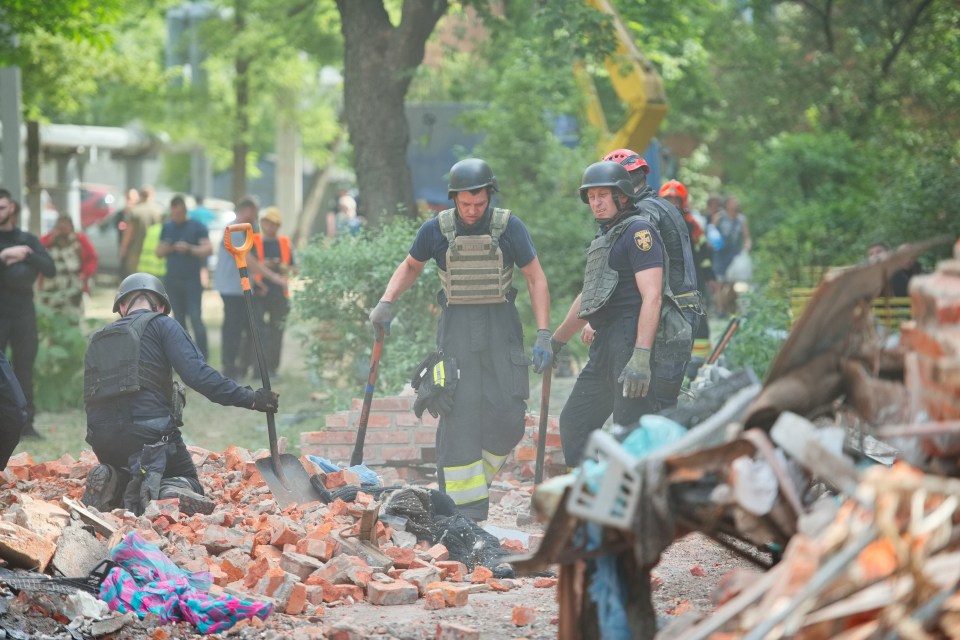 First responders sift through debris after a Russian blitz on a residential area in Kharkiv