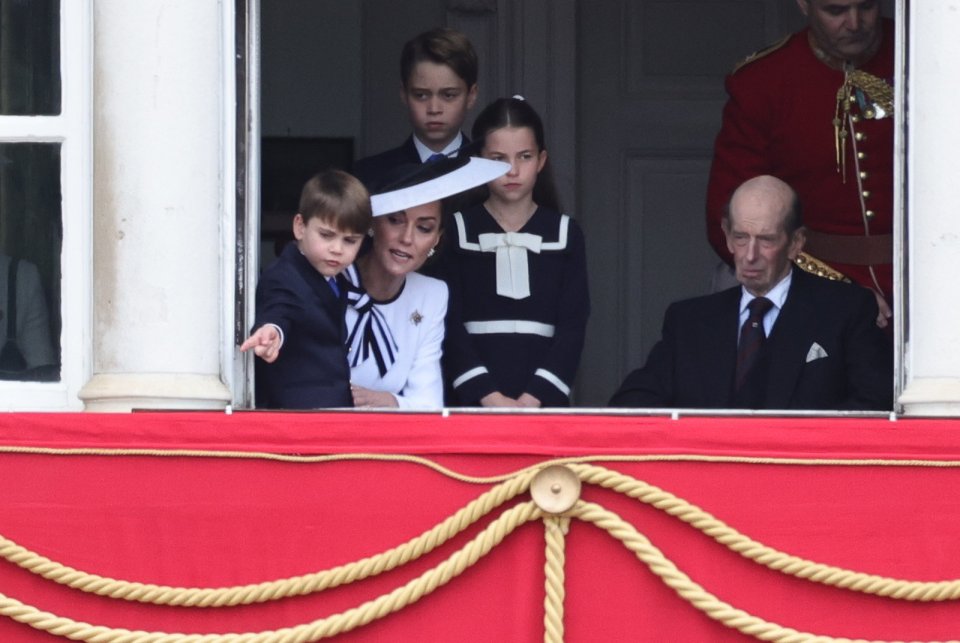 She and Prince Louis were snapped peeking out a window