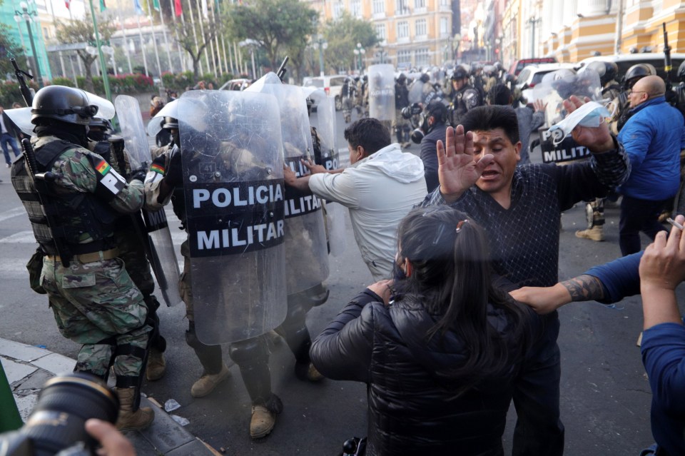 Followers of Bolivian President Luis Arce protest against military personnel trying to enter the government headquarters in La Paz