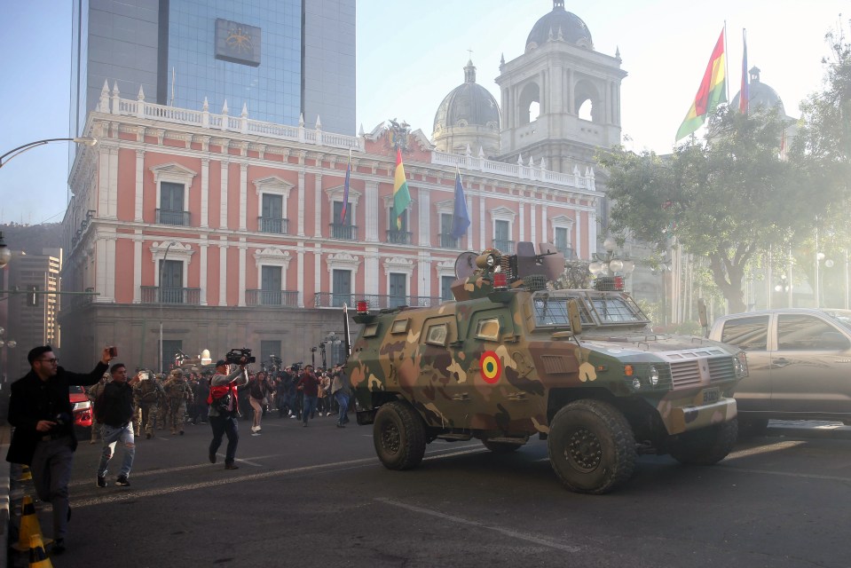 A military vehicle moves near the government headquarters in La Paz