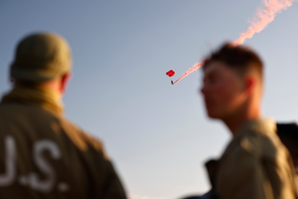 Participants watch during a ceremony at Utah Beach near Saint-Martin-de-Vareville