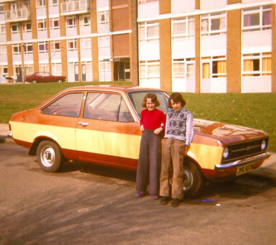 Chris with his sister outside the estate in Leeds he grew up in