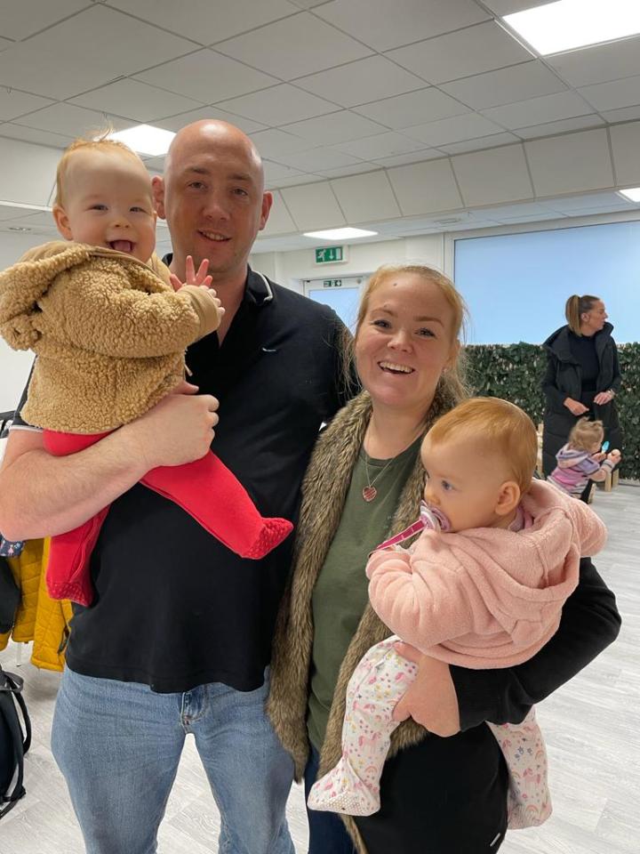 A smiling Amy with husband Matt and twins Violet and Fred