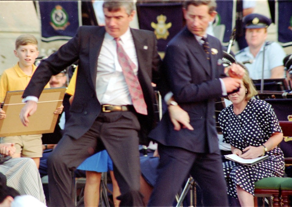 A bodyguard throwing himself in front of Prince Charles