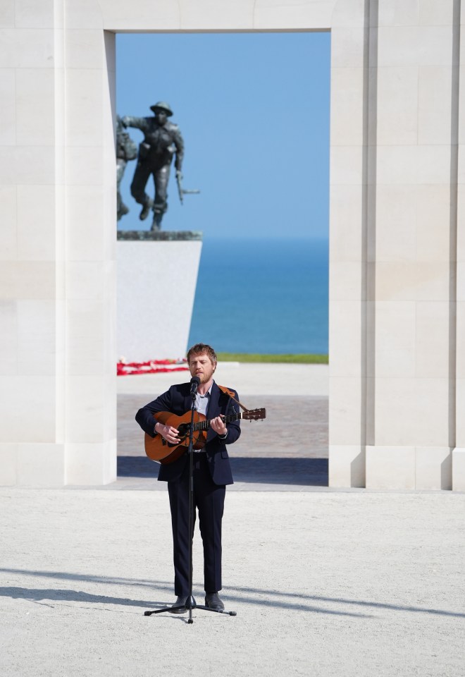 Johnny Flynn performs a song during the commemorative event