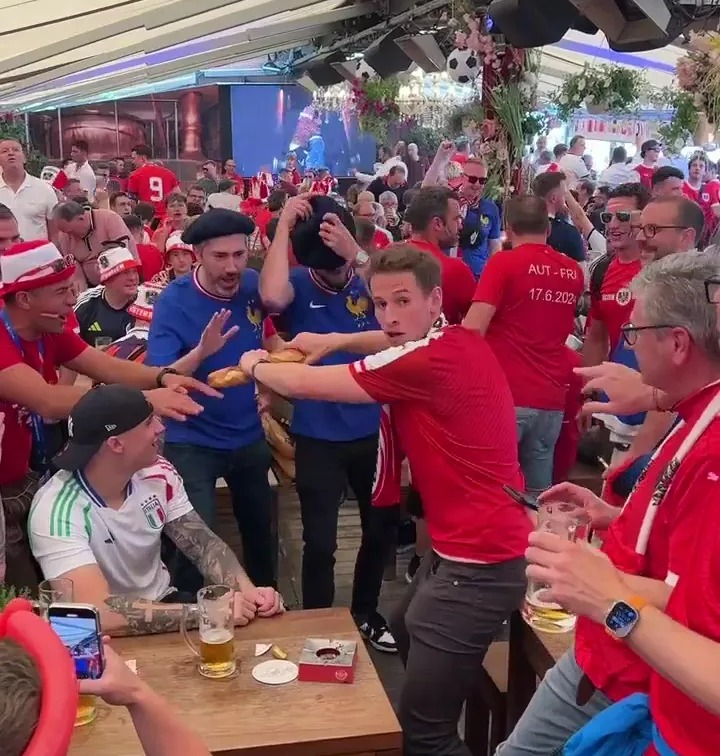 An Austria fan snapped a baguette in front of France fans