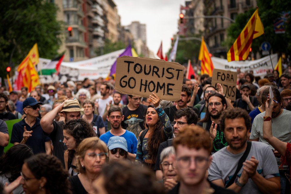 Demonstrators march shouting slogans in downtown Barcelona