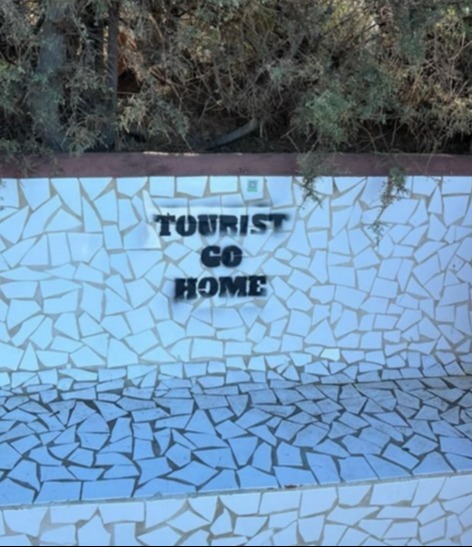 Anti-tourist graffiti has appeared on walls across the island