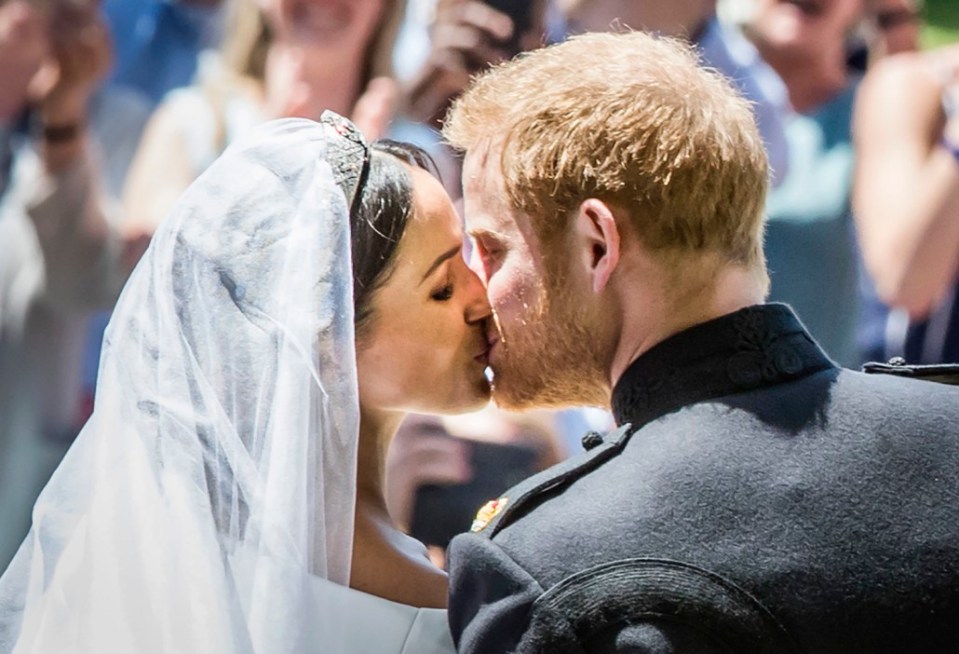  Prince Harry, Duke of Sussex kisses his wife Meghan, Duchess of Sussex after their ceremony