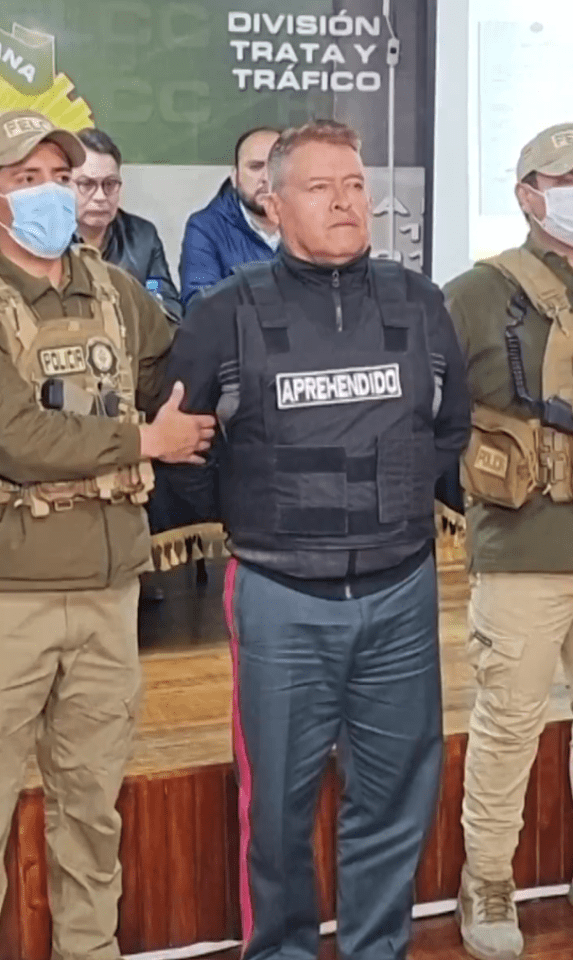 Wearing a vest written "aprehended" on it, the ex military chief was paraded by police officers