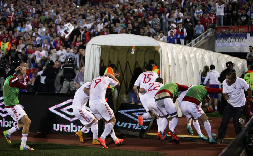 Albania fans were forced to take cover as projectiles were lobbed onto the pitch in 2014