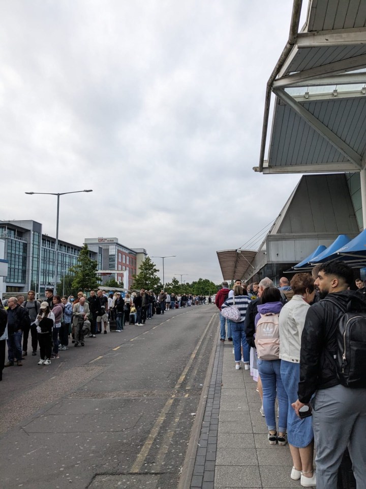 Passengers queuing outside Birmingham Airport’s front door this morning