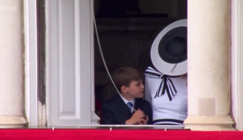 Prince Louis fiddles with curtain cords on the balcony