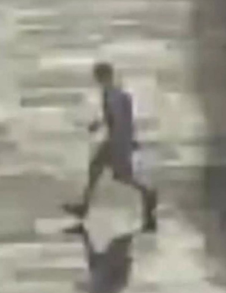 a blurry picture of a man walking down stairs .