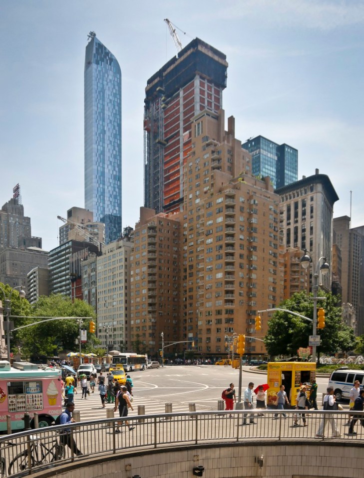 A luxury 90-floor apartment skyscraper called "One57," left, rises above all other buildings overlooking Central Park, while a crane sits atop ongoing construction for a new condominium skyscraper at 220 Central Park South, Thursday May 26, 2016, in New York. A penthouse in One57 went for $100.5 million in 2014, but an apartment in the new condominium is expected to sell for $250 million. (AP Photo/Bebeto Matthews)