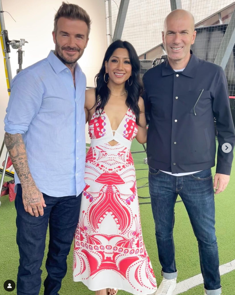 a woman in a red and white dress poses with two men