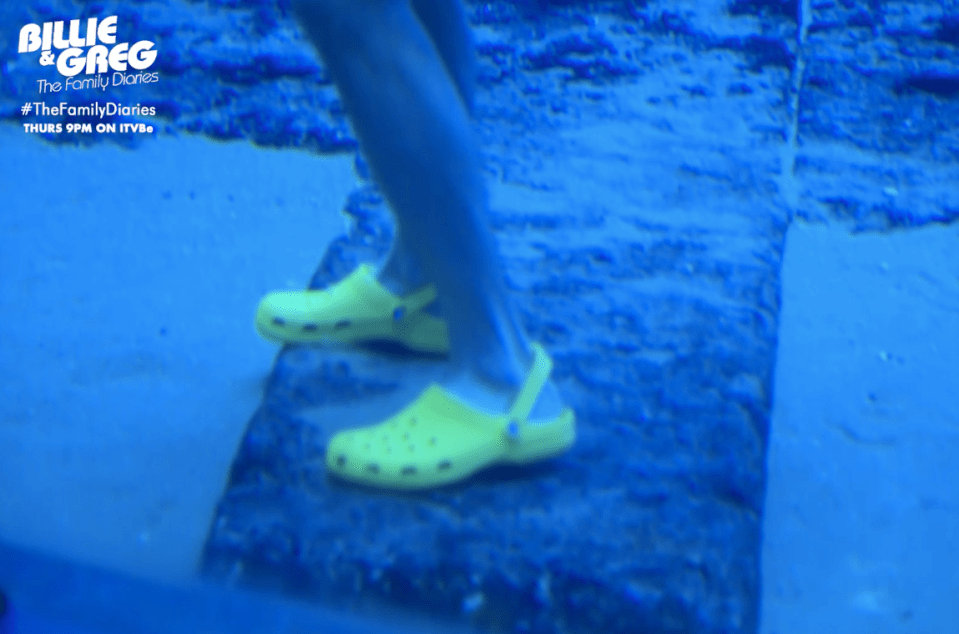 Greg is wearing bright yellow Crocs in the tank