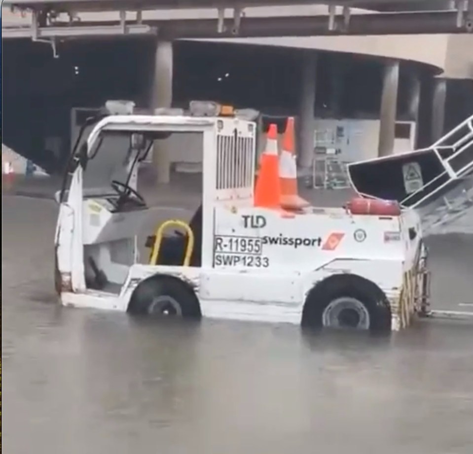 A pushback tractor half-submerged in water