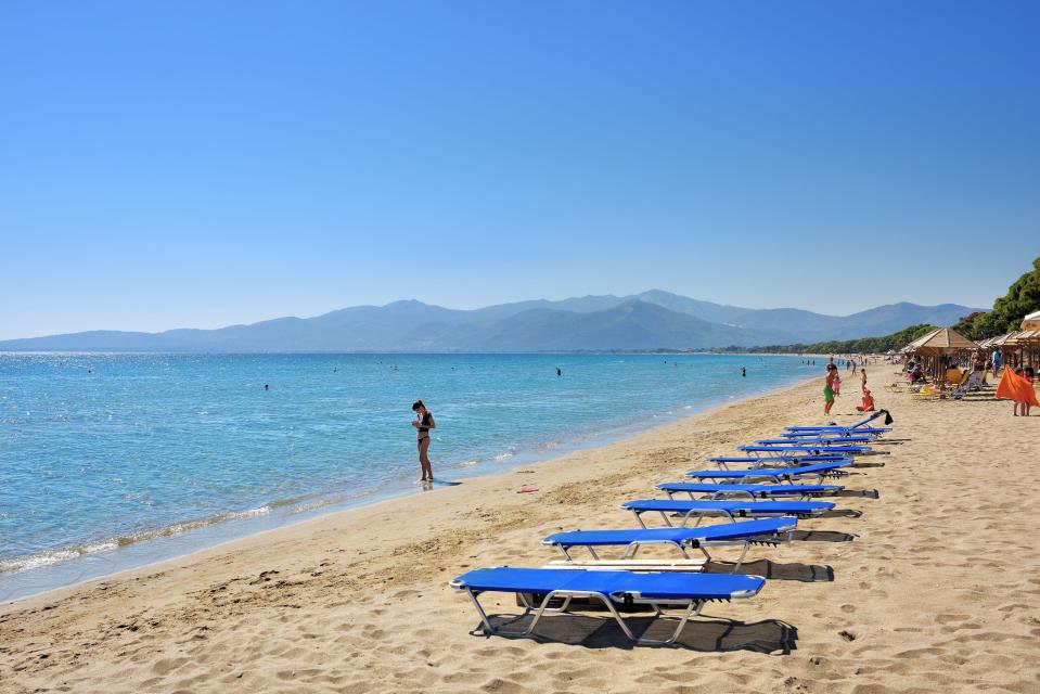 The lifeless body of a man has been found near a popular Greek beach with a 10kg barbell tied to his leg