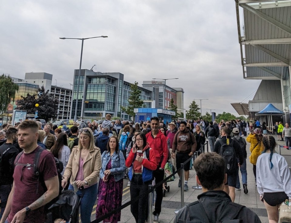 Passengers queuing outside Birmingham Airport’s front door this morning