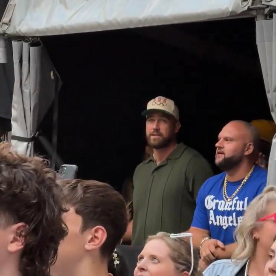 Travis, in dark green with baseball cap, at Wembley cheering on Taylor