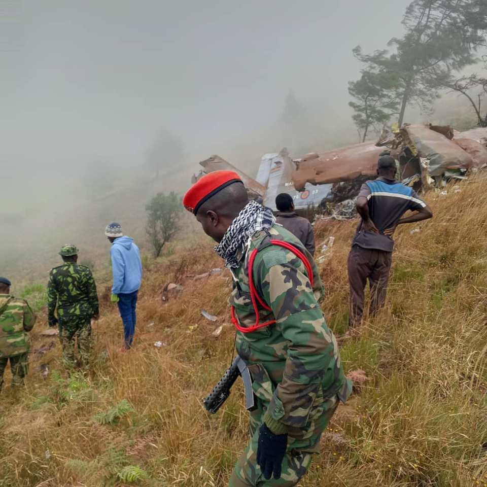 Search crews at the wreckage site in the Viphya Mountains