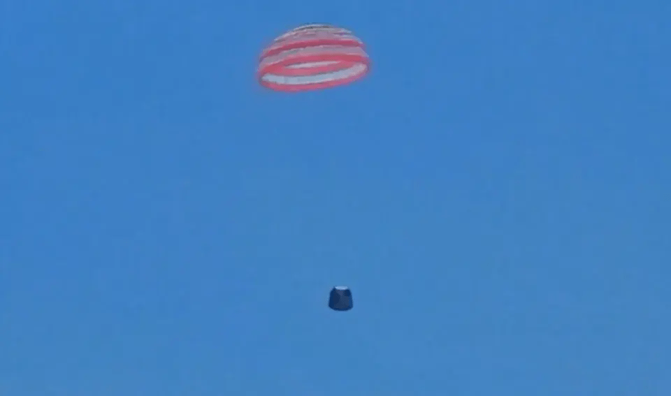 The probe is seen floating in the blue sky as experts wait for its descent