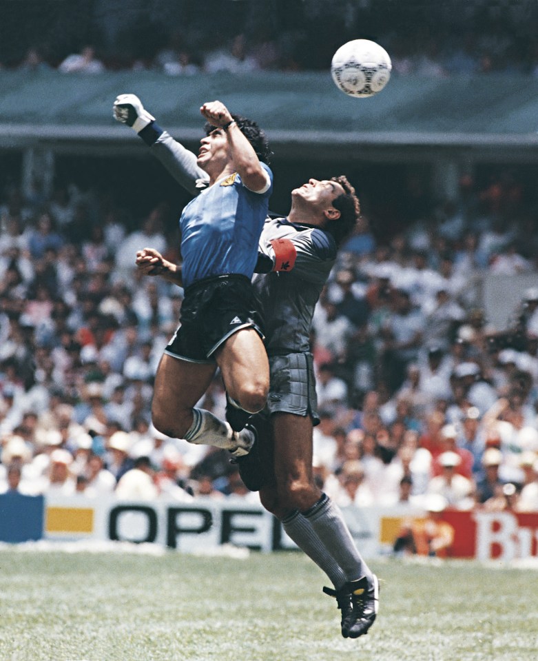 Diego Maradona rises to the ball with his hand at the 1986 World Cup