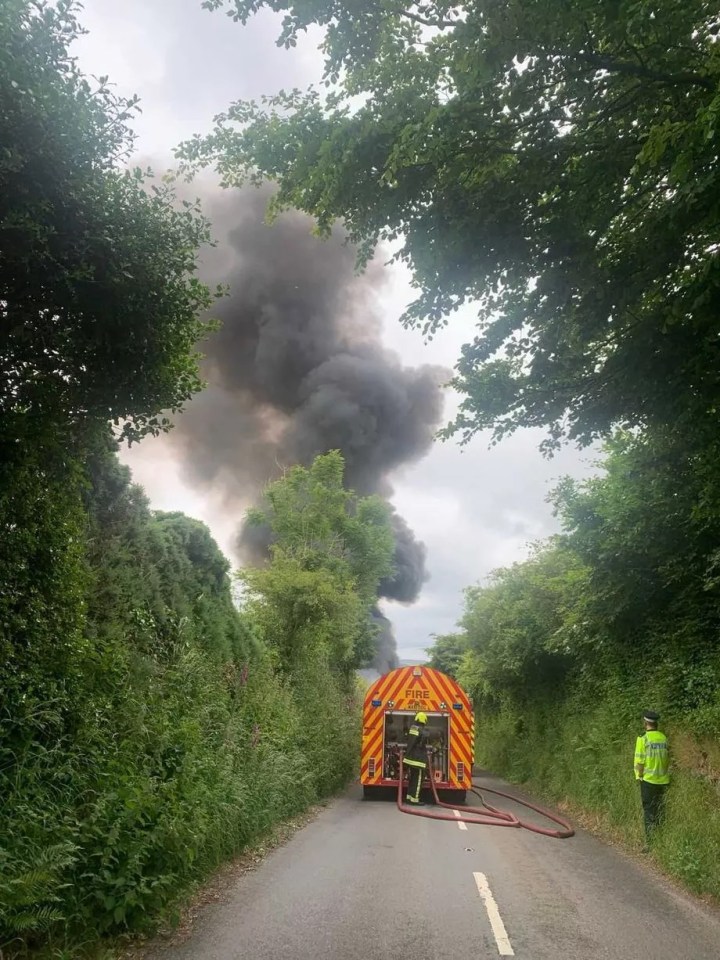 Black smoke pours into the sky